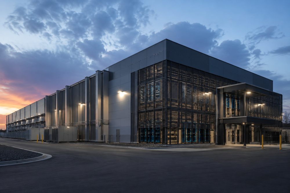Hyperscale data center building exterior at dusk